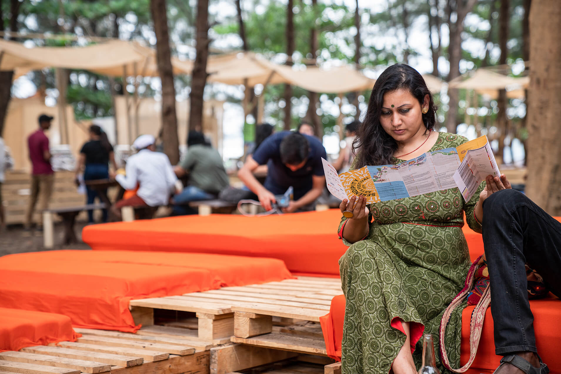 Photo of a woman referring to the map and schedule for SAF 2019